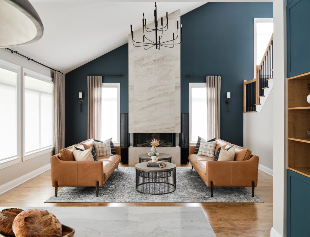 A living room with blue walls and a fireplace