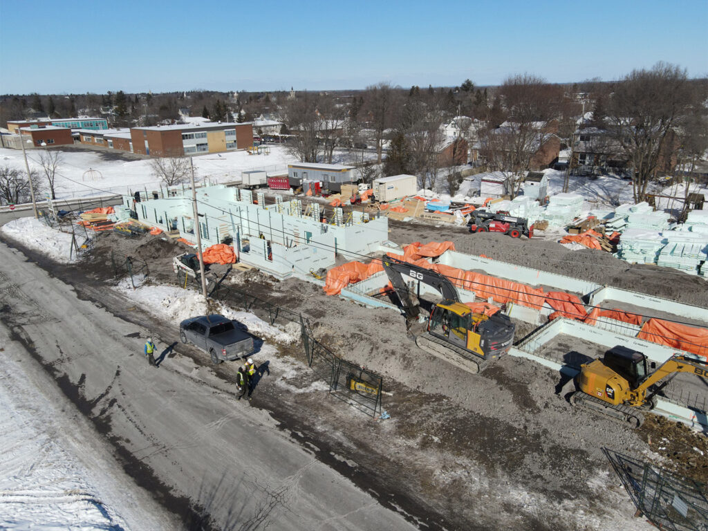 Aerial view of Boyd Street construction site with exposed insulation panels and construction machinery